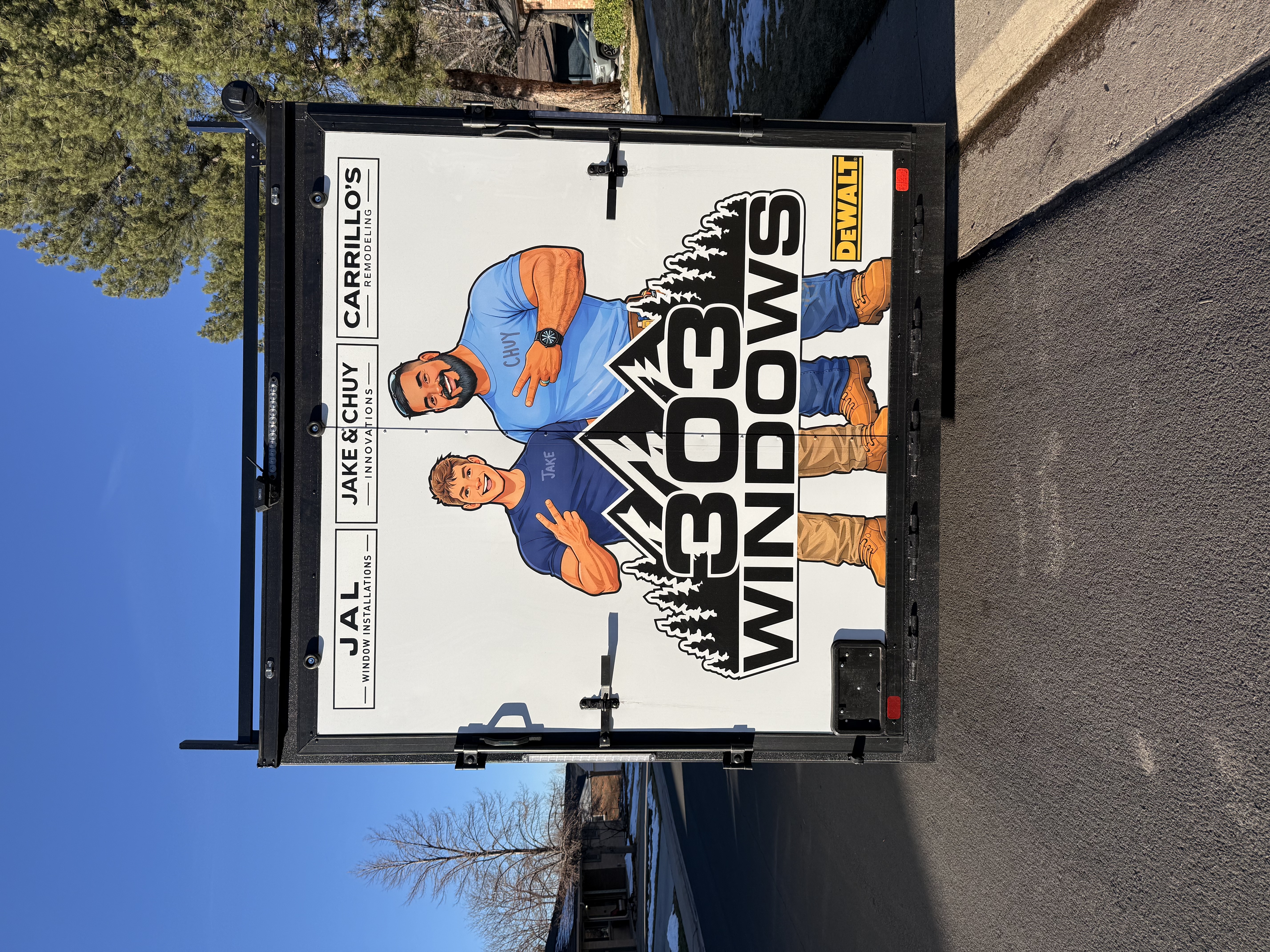 Large-scale 303 Windows trailer wrap featuring illustrated workers and a mountain logo