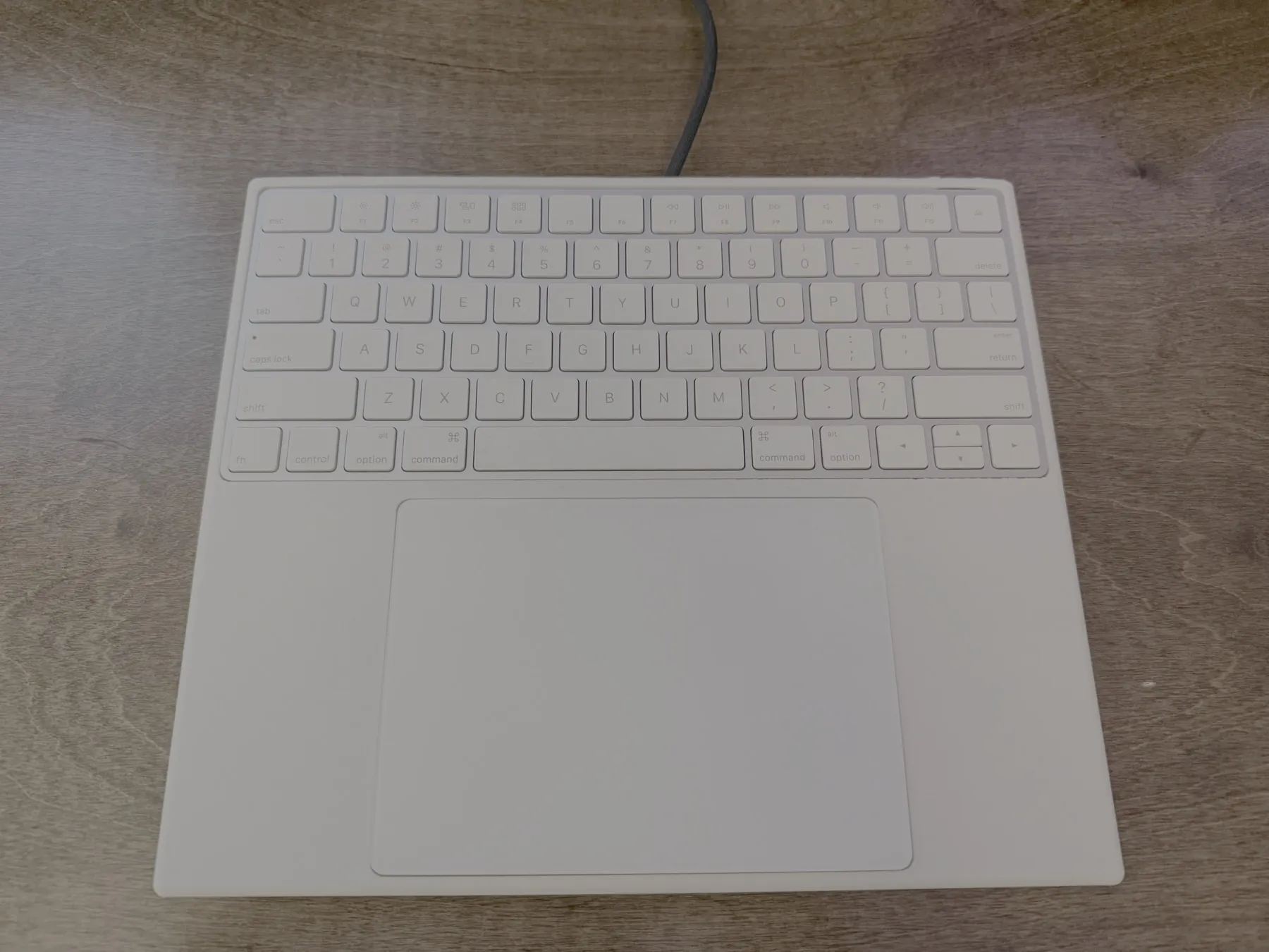 Vision Pro keyboard tray render with spaces for an Apple Magic Keyboard and Magic Trackpad