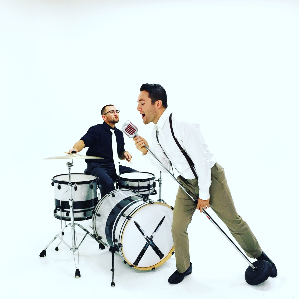 Musicians performing against a white backdrop