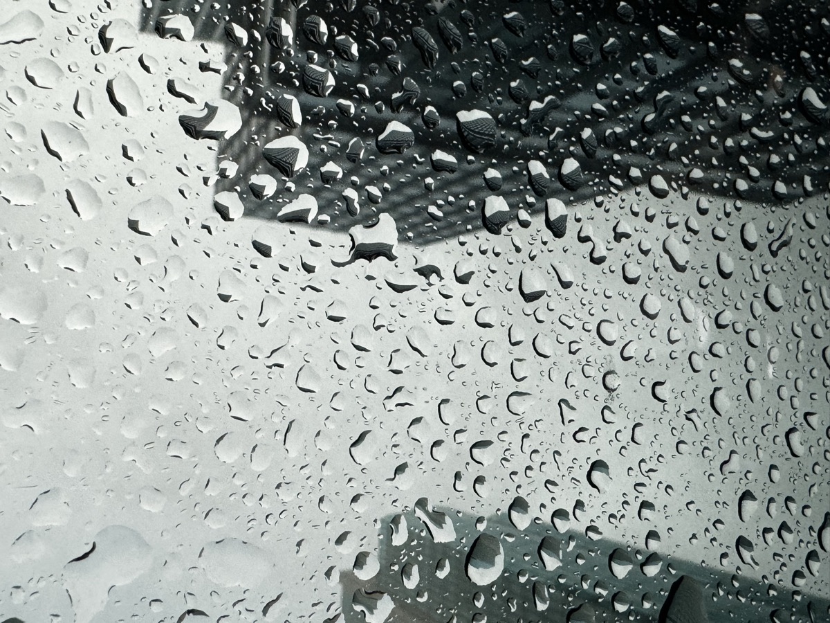 Rain on glass with an urban reflection